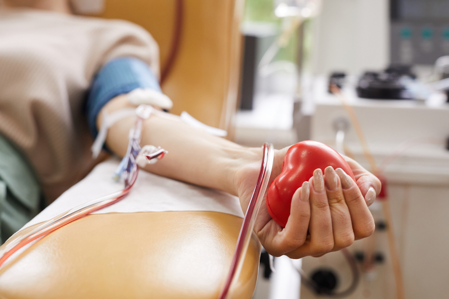 close-up-patient-with-tubes-her-arm-squeezing-ball-her-hand-while-donating-blood.jpg